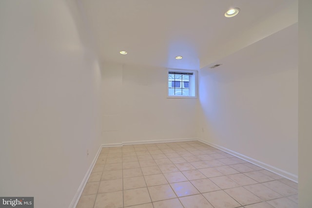 spare room with recessed lighting and baseboards