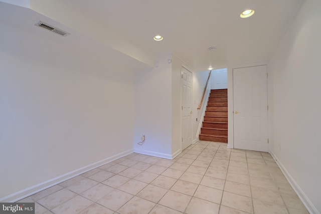 empty room featuring recessed lighting, visible vents, baseboards, and stairs