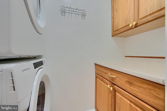 laundry area with cabinet space and washer / dryer