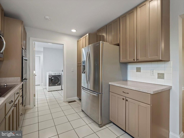 kitchen with light countertops, light tile patterned flooring, stainless steel refrigerator with ice dispenser, washer / dryer, and decorative backsplash