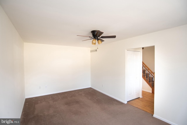 unfurnished room featuring visible vents, baseboards, a ceiling fan, and carpet flooring