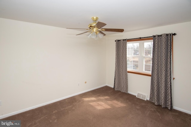 carpeted spare room with a ceiling fan, baseboards, and visible vents