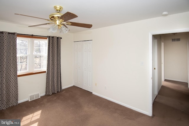 carpeted empty room featuring visible vents and baseboards