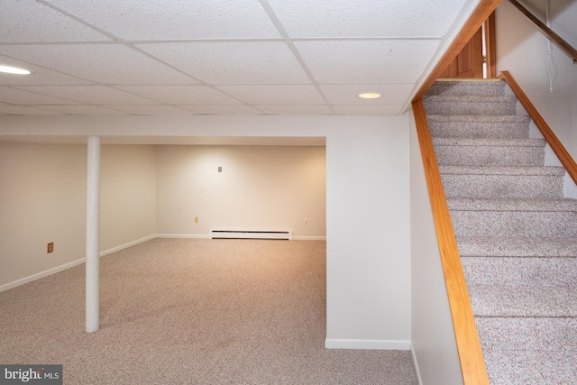 staircase with a baseboard heating unit, baseboards, and carpet floors