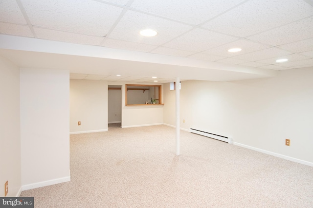 finished basement with baseboards, carpet floors, recessed lighting, a drop ceiling, and a baseboard heating unit