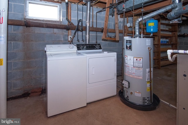 washroom with washing machine and clothes dryer, laundry area, and gas water heater