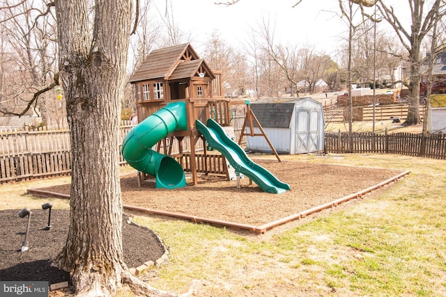 view of play area featuring an outbuilding, a storage unit, and fence