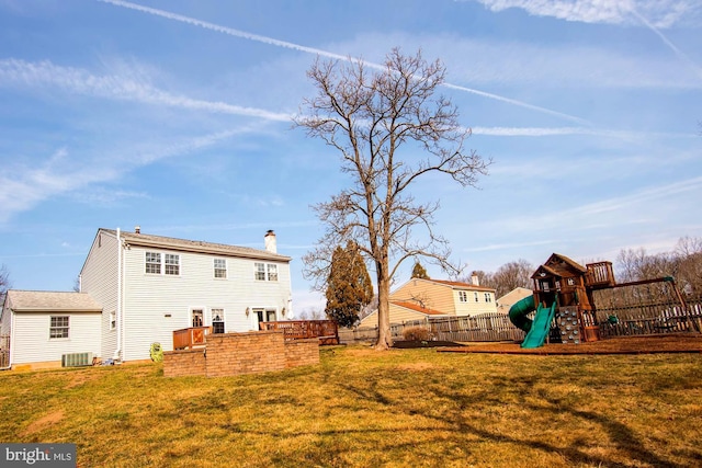 view of yard with central air condition unit, a playground, and fence