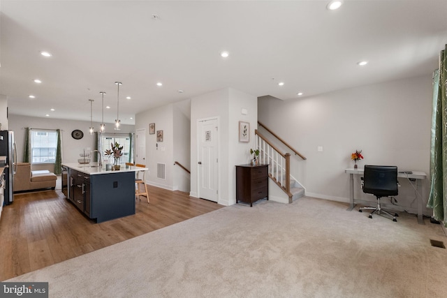 kitchen with visible vents, freestanding refrigerator, recessed lighting, carpet flooring, and light countertops