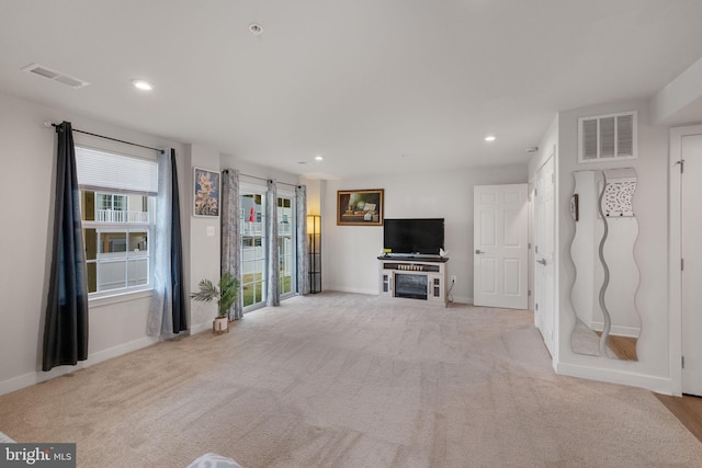 unfurnished living room with recessed lighting, visible vents, and baseboards