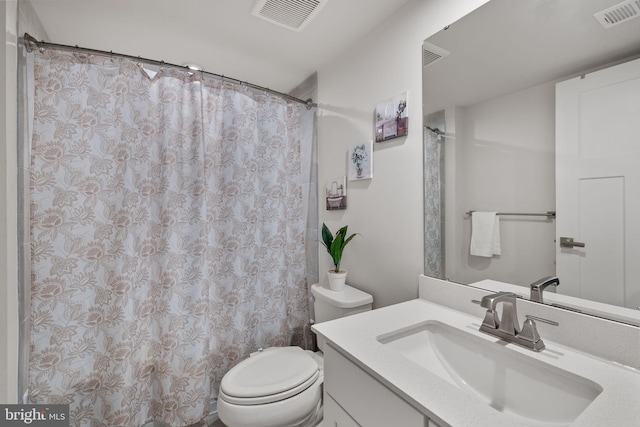 bathroom with visible vents, toilet, vanity, and a shower with curtain