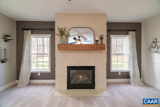 details featuring a stone fireplace, carpet flooring, and baseboards