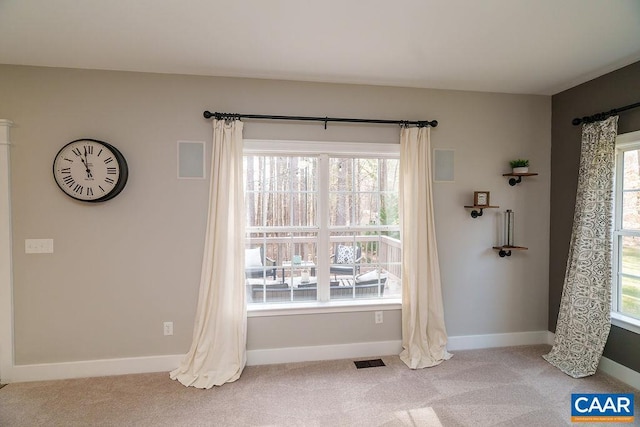 carpeted empty room with visible vents and baseboards