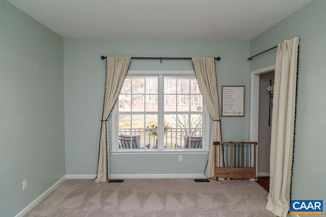 unfurnished room featuring visible vents, baseboards, and carpet