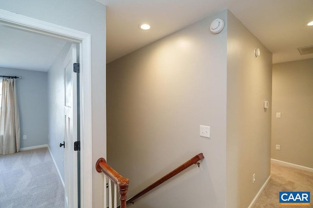 corridor with recessed lighting, baseboards, an upstairs landing, and light colored carpet