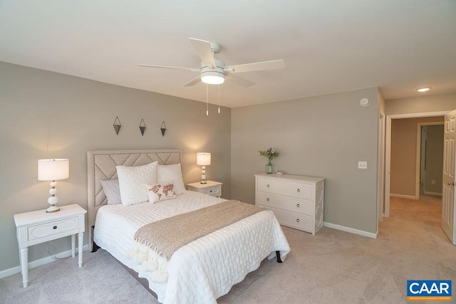 bedroom featuring light carpet, ceiling fan, and baseboards