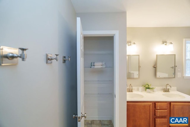 full bath featuring a sink and double vanity