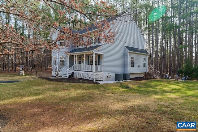 exterior space with cooling unit, a porch, and a front yard