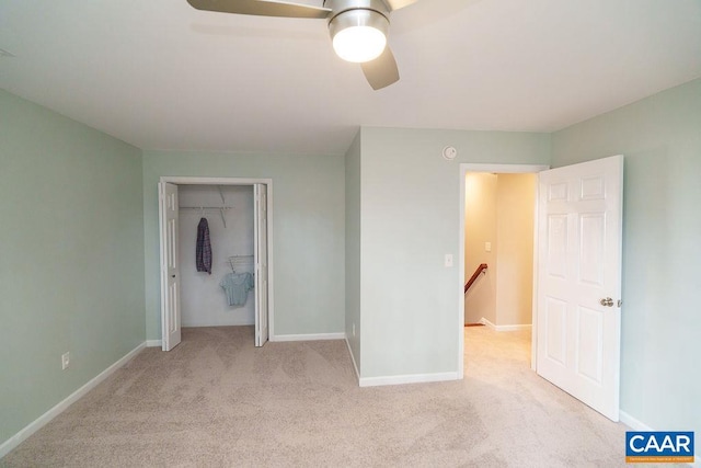 unfurnished bedroom featuring a closet, baseboards, carpet, and a ceiling fan