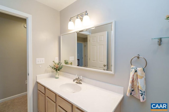 bathroom with baseboards and vanity