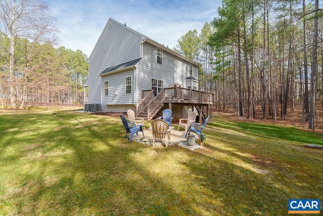 back of house featuring a deck, stairs, a fire pit, and a yard