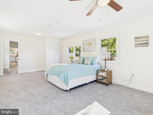 bedroom with visible vents, ceiling fan, baseboards, carpet, and a closet