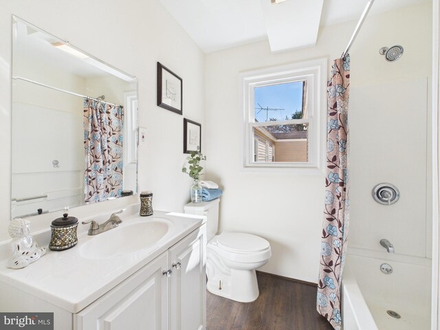 full bath featuring shower / bath combo, toilet, vanity, and wood finished floors