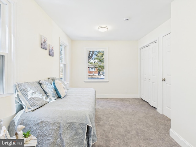 bedroom with a closet, baseboards, and carpet floors