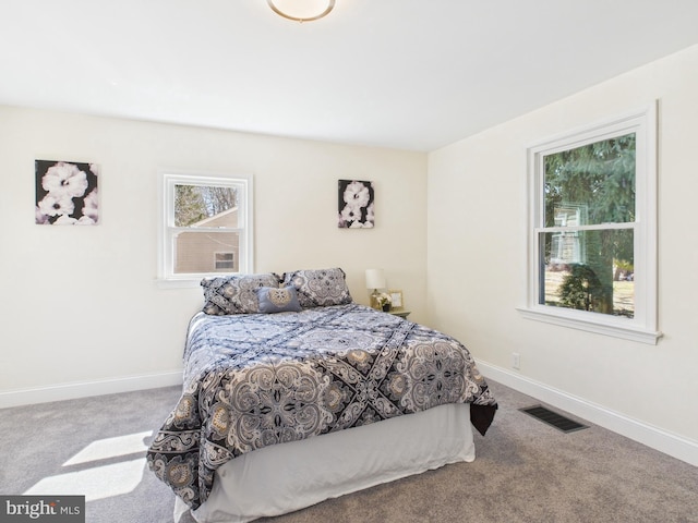 bedroom with visible vents, baseboards, and carpet floors