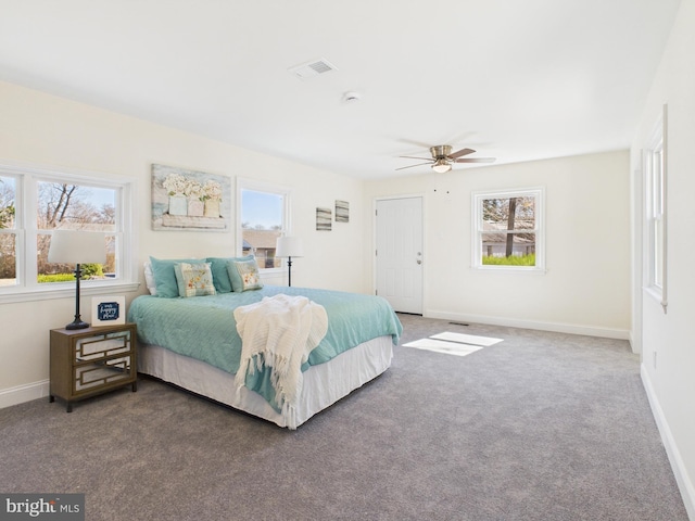 bedroom with a ceiling fan, visible vents, baseboards, and carpet floors