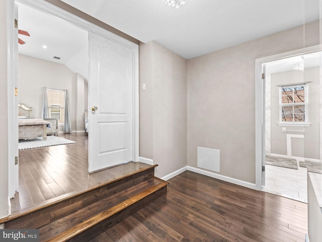 interior space featuring a healthy amount of sunlight, baseboards, and wood finished floors