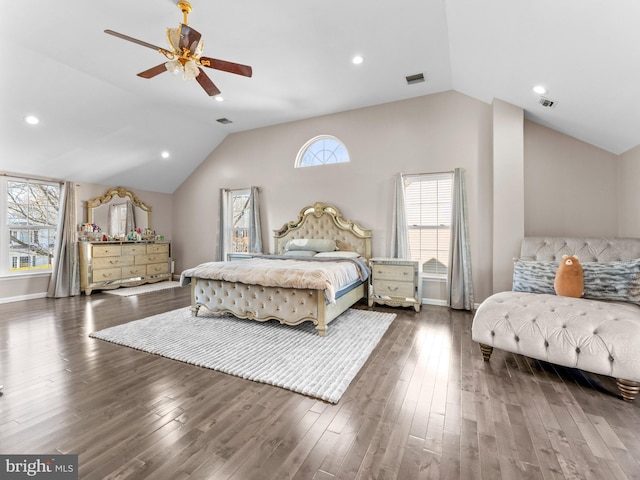 bedroom with lofted ceiling, wood finished floors, and visible vents