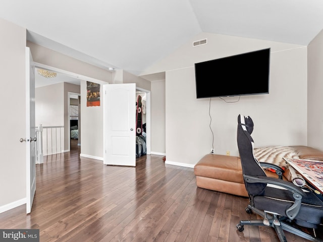 home office featuring visible vents, baseboards, lofted ceiling, and wood-type flooring