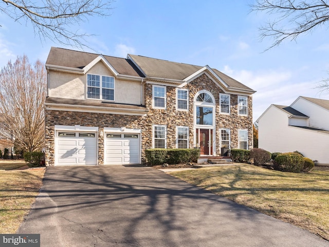 view of front facade featuring aphalt driveway, a garage, a front lawn, and stucco siding