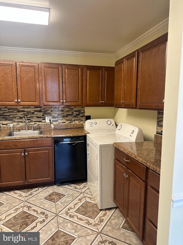 washroom with crown molding, washer and clothes dryer, light tile patterned floors, laundry area, and a sink