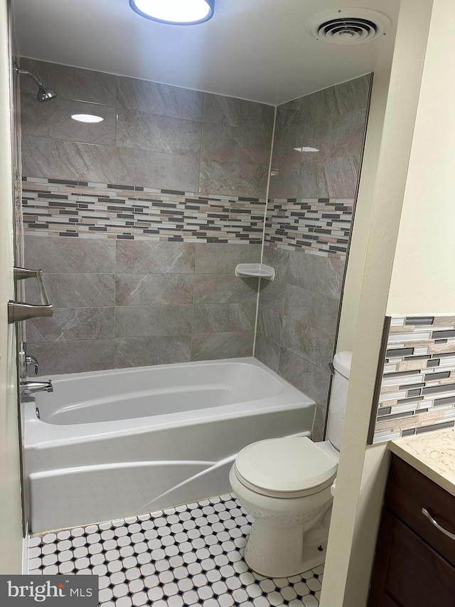 bathroom featuring visible vents, toilet, vanity, and shower / bathing tub combination