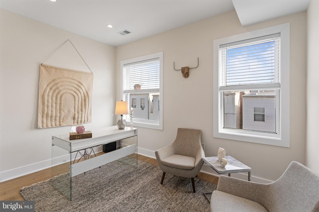 living area with visible vents, recessed lighting, baseboards, and wood finished floors