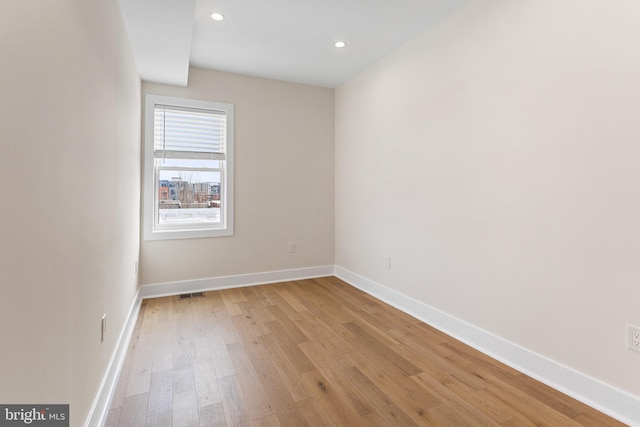 spare room with visible vents, recessed lighting, baseboards, and light wood finished floors