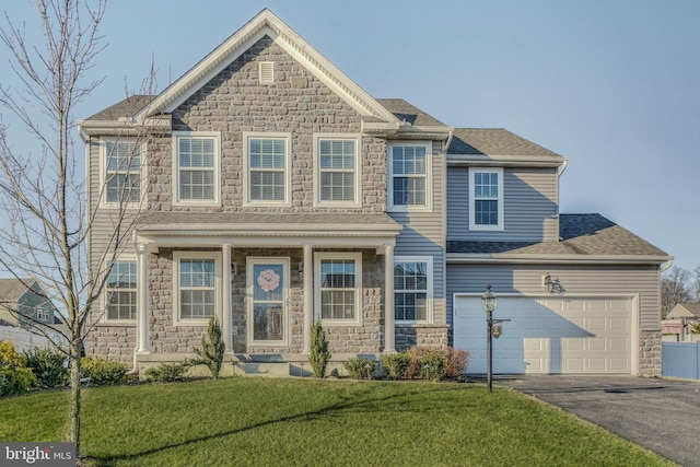 view of front of house featuring aphalt driveway, stone siding, a front lawn, and roof with shingles