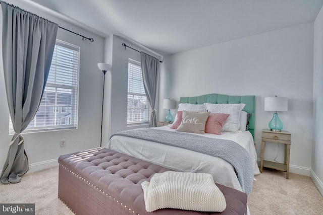 carpeted bedroom featuring baseboards