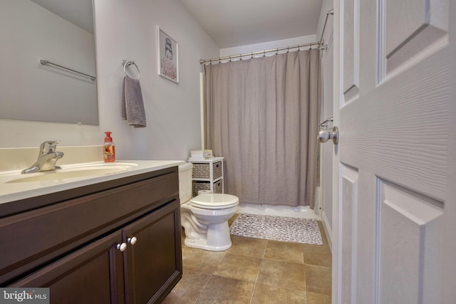 bathroom featuring a shower with shower curtain, toilet, vanity, and tile patterned floors