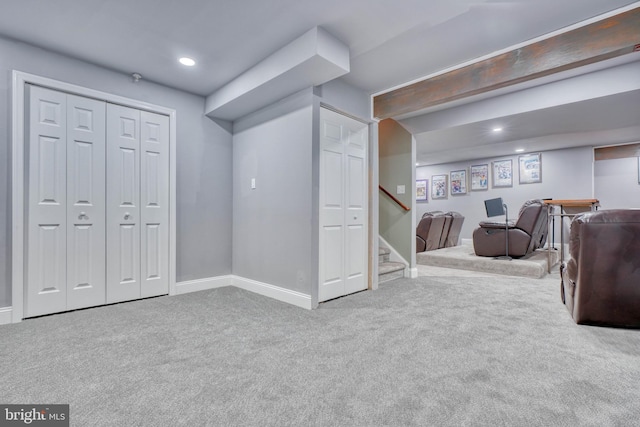 finished basement featuring stairway, recessed lighting, baseboards, and carpet