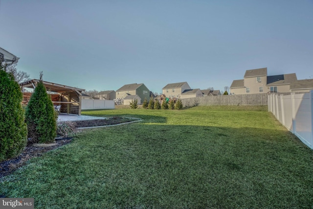 view of yard with a fenced backyard and a residential view