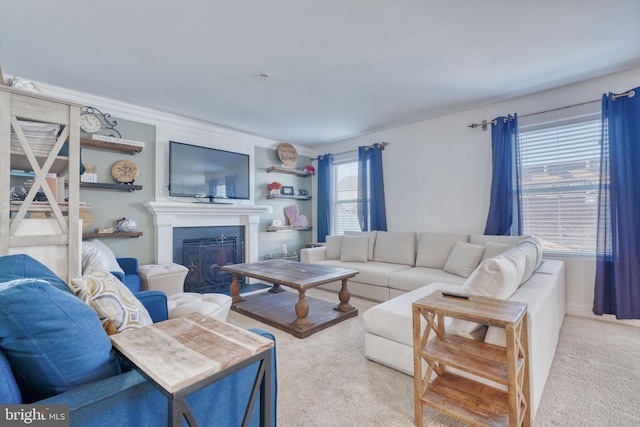 carpeted living room featuring a glass covered fireplace