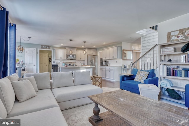 living area with recessed lighting and stairs