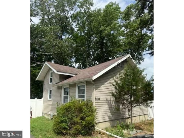 view of side of home featuring fence