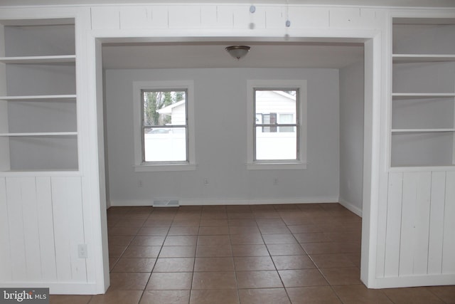 208 S Brewster Rd, Vineland, NJ 08361 - spare room featuring tile patterned floors, visible vents, built in shelves, and baseboards
