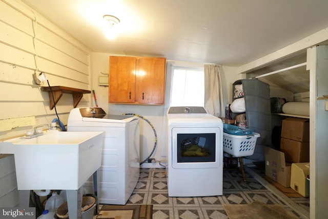 washroom featuring tile patterned floors, cabinet space, independent washer and dryer, and a sink