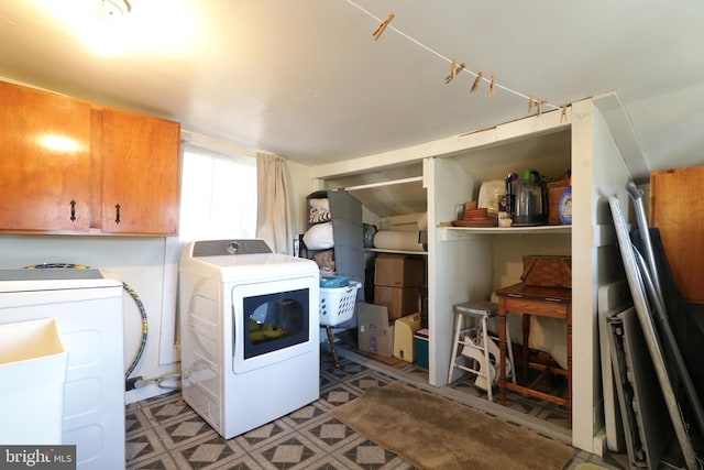 laundry area with washer and dryer, tile patterned floors, and cabinet space