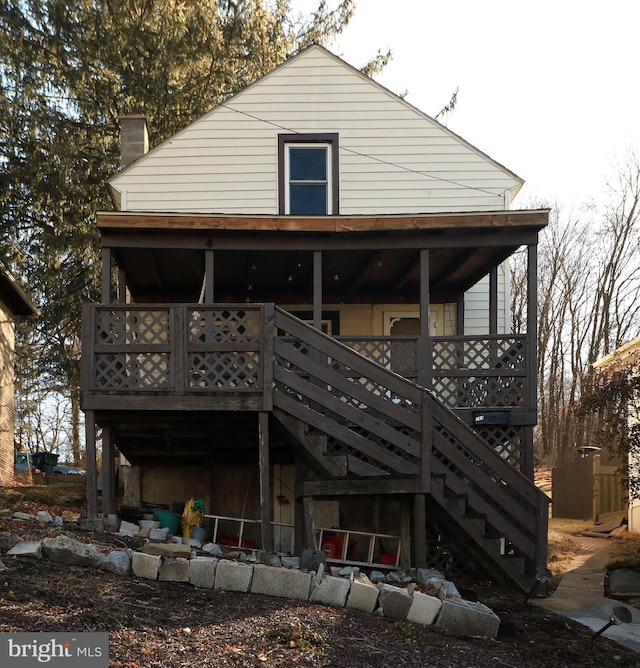 back of property featuring stairway